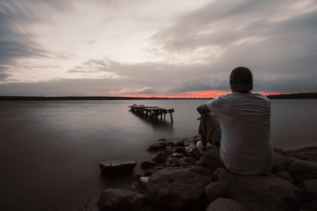 a lonely man sitting beside the beach - Types Of Depression?