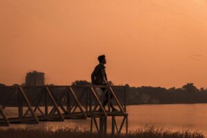 a man sitting beside the sea shore 