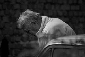 an old sad man in white thinking - What Is Bipolar Depression?