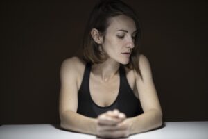 a depressed woman thinking with her hand crossed